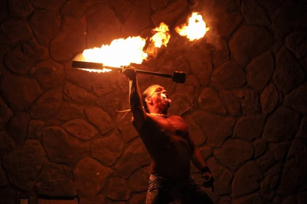 Fire dancer spinning torches at Wailea Luau in Maui.